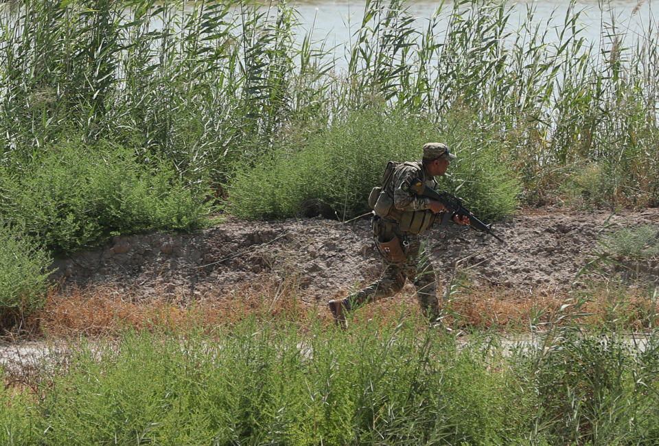 FILE - In this Tuesday, July 23, 2019 file photo, an Iraqi soldier searches for Islamic State militants during search operation in Taramiyah, north of Baghdad, Iraq. Islamic State militants in Iraq and Syria are stepping up attacks, taking advantage of governments preoccupied with the economic and health impact of the coronavirus. Security officials in Iraq say attacks are up fivefold over last year, as the group exploits security gaps linked to the virus lockdown and a U.S. troop drawdown in the country’s north. (AP Photo/Hadi Mizban, File)