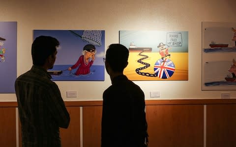 Caricatures at Iran's "Pirates of the Queen" exhibit mocks the UK over its seized tanker - Credit: ATTA KENARE/AFP/Getty Images