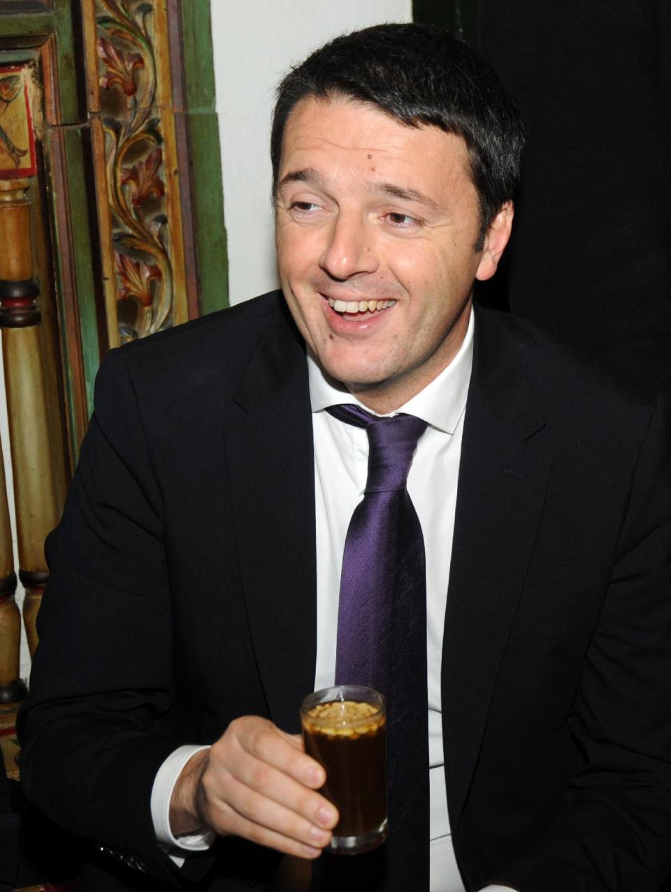 Italian Premier, Matteo Renzi , enjoys a glass of tea with pine nuts during a meeting with members of the Tunisian civil society at the cafe des Nattes in Sidi Bou Said, north of the Tunisian capital Tunis, Tuesday, March 4, 2014. Earlier in the day Renzi had met the Tunisian President, Moncef Marzouki, and his Tunisian counterpart, Mehdi Jomaa. (AP Photo/Hamadi Ben Taieb)