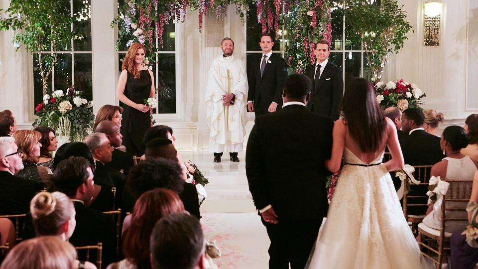 Meghan Markle in character as Rachel Zane walking down the aisle