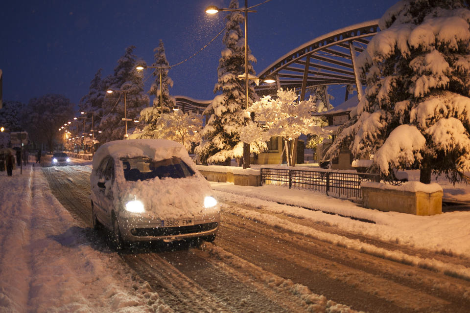 A man drives his car through a street covered with snow after a snowfall at the city of Ronda, southern Spain, Thursday, Jan. 19, 2017. The schools of Ronda, one of the most historical towns of Andalusia, suspended their classes Thursday and traffic has been interrupted on several highways due to the intense snowfall that has fallen during the night. A cold spell has reached Europe with temperatures plummeting far below zero. (AP Photo/Javier Gonzalez)