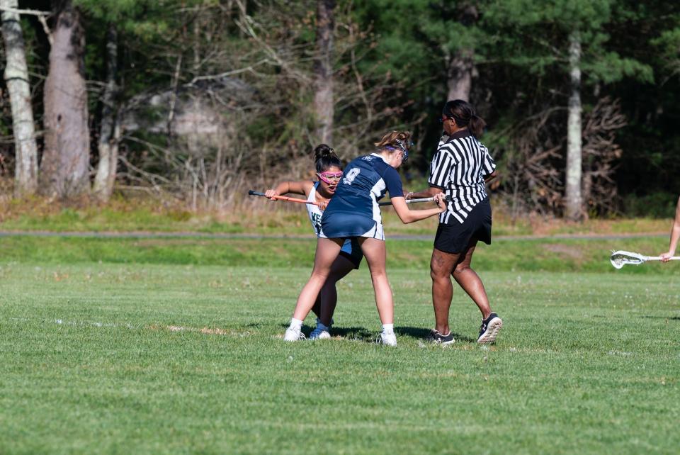 Monomoy's #9, Lucy Mawn, and Sturgis West's #17, Jinpei Holmes, set up for the face-off in the Monomoy vs. Sturgis West lacrosse game at McBarron Field.