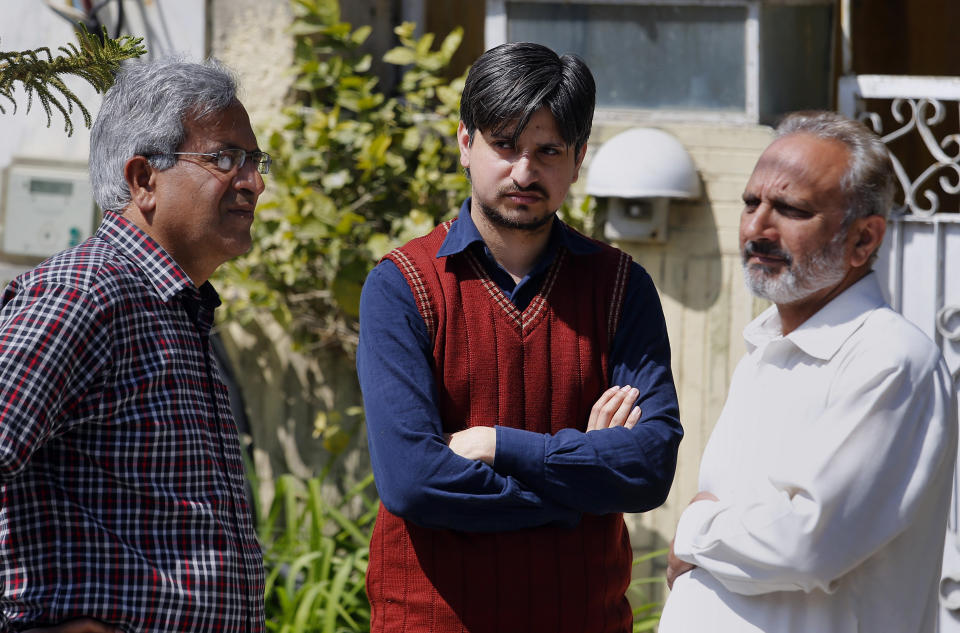 Relatives offer condolence to nephew, center, of Haroon Mahmood, a Pakistani citizen who was killed in Christchurch mosque shootings, at his family home in Islamabad, Pakistan, Sunday, March 17, 2019. Pakistan's foreign ministry spokesman says three more Pakistanis have been identified among the dead increasing the number of Pakistanis to nine killed in the mass shootings at two mosques in the New Zealand city of Christchurch. (AP Photo/Anjum Naveed)