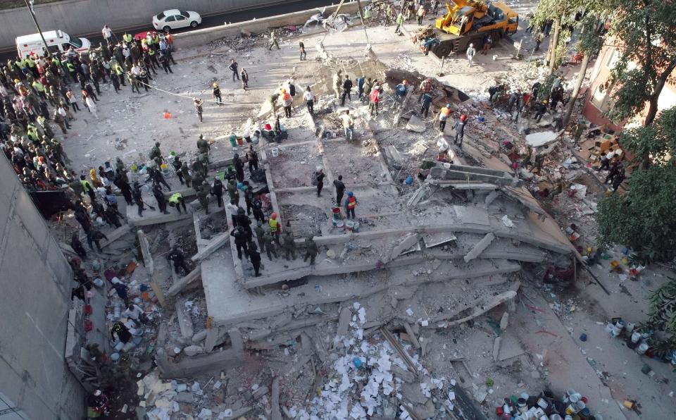 Rescuers look for survivors in a multistory building.