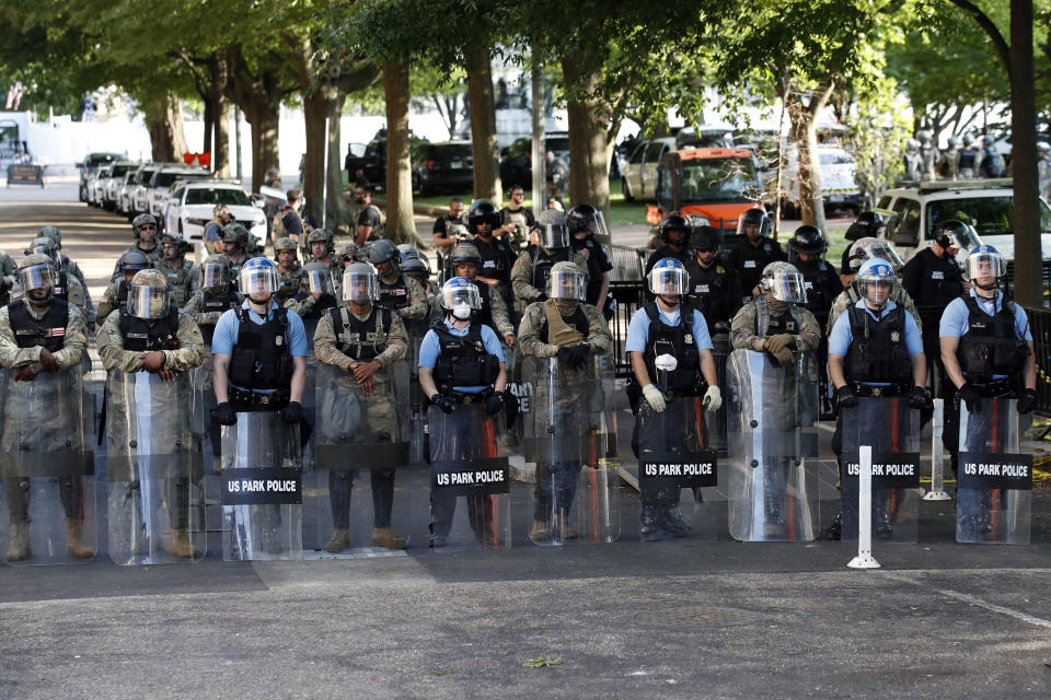 Members of the DC National Guard, U.S. Park Police and U.S. Secret Service watch from Lafayette Park as demonstrators gather to protest the death of George Floyd, Tuesday, June 2, 2020, near the White House in Washington. Floyd died after being restrained by Minneapolis police officers. (AP Photo/Alex Brandon)