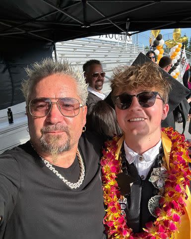 <p>Guy Fieri/Instagram</p> Guy Fieri poses for a selfie with his son Ryder during Ryder's high school graduation ceremony in June 2024