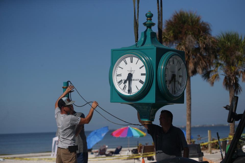 Crews with the Verdin Company and Kell]y General Contracting install the new clock in Times Square on Fort Myers Beach on Thursday, Sept. 14, 2023. The original clock was destroyed after Hurricane Ian decimated the island on Sept. 28, 2022 . The clock will be covered until it is unveiled during a ceremony on Sept. 28, 2023.
