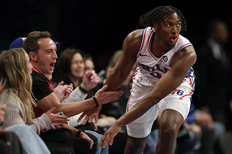 Philadelphia 76ers guard Tyrese Maxey reacts with fans after making a basket during the second half of an NBA basketball game, Sunday, Nov. 19, 2023, in New York. (AP Photo/Adam Hunger)