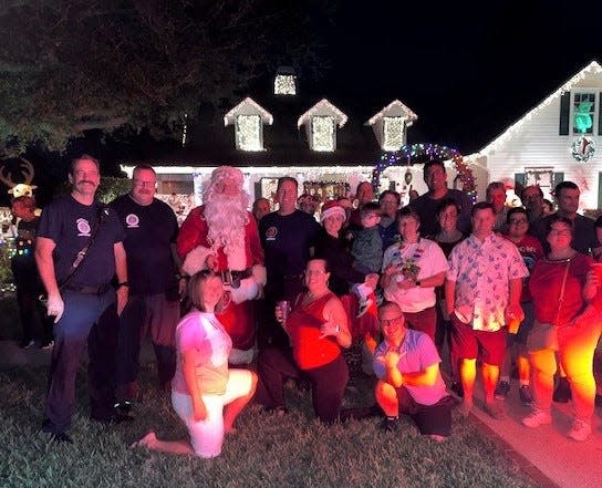 Members of the Special Olympics Swim & Surf Teams are pictured with local firefighters, family, friends and Santa Claus at the home of Maxwell Zahn, who hosts a Christmas party for the young people each year.