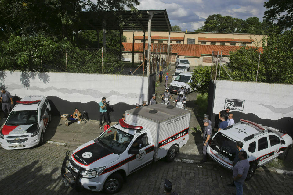 FILE - In this March 13, 2019, file photo, a fleet of funeral vans transport the bodies of the people who were killed in a school shooting at the Raul Brasil State School in Suzano, Brazil. The 1999 Colorado attack continues to motivate mass shooters, including the two men who stormed their former school in Brazil, killing seven people. (AP Photo/Andre Penner, File)