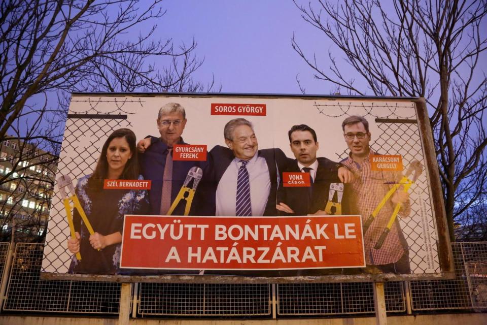 A political billboard by Hungary's ruling party shows George Soros and his allies breaching the border fence to try and re-take Hungary. The Incumbent Fidesz-party Prime Minister has driven media campaigns against Mr Soros for years - branded as anti-Semitic in 2017. (Getty Images)