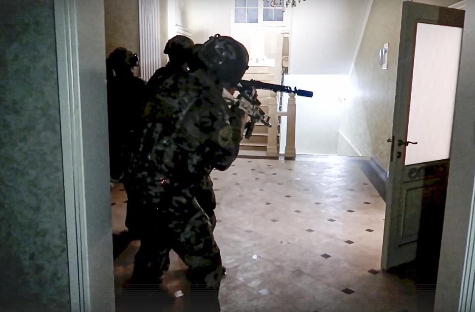 In this photo taken from video released by the National Antiterrorism Committee on Monday, June 24, 2024, FSB officers conduct a counter-terrorist operation in republic of Dagestan, Russia. Multiple police officers and several civilians, including an Orthodox priest, were killed by armed militants in Russia’s southern republic of Dagestan on Sunday, its governor Sergei Melikov said in a video statement early Monday. (The National Antiterrorism Committee via AP)