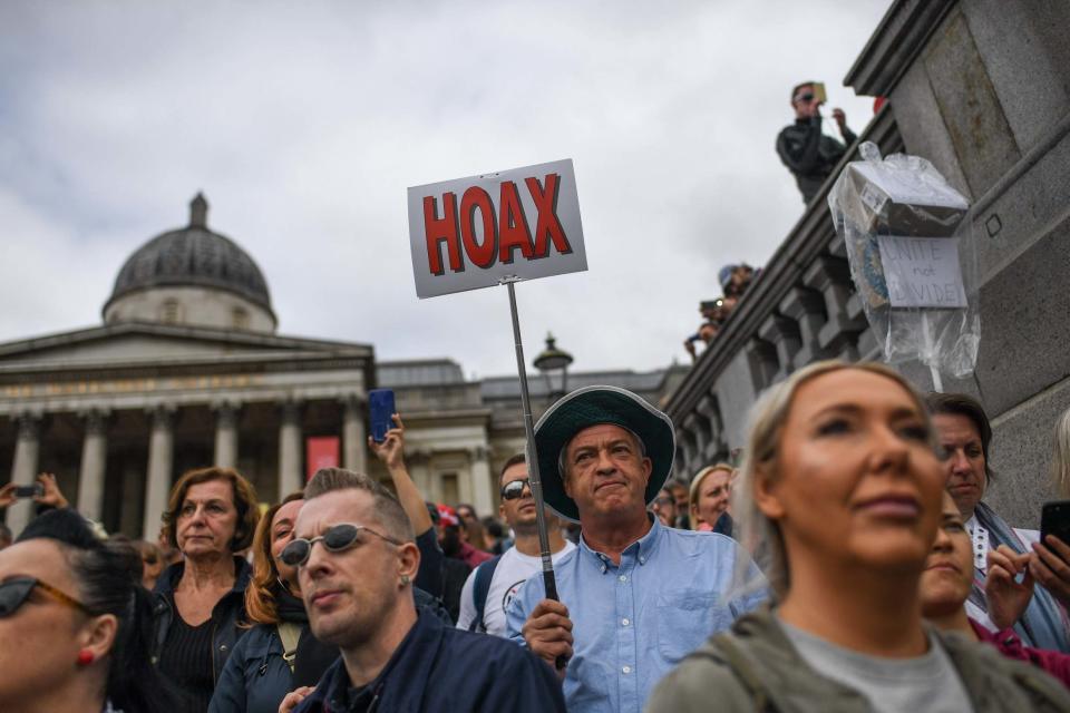 Protesters waved placards branding the pandemic a 'hoax' (Getty Images)