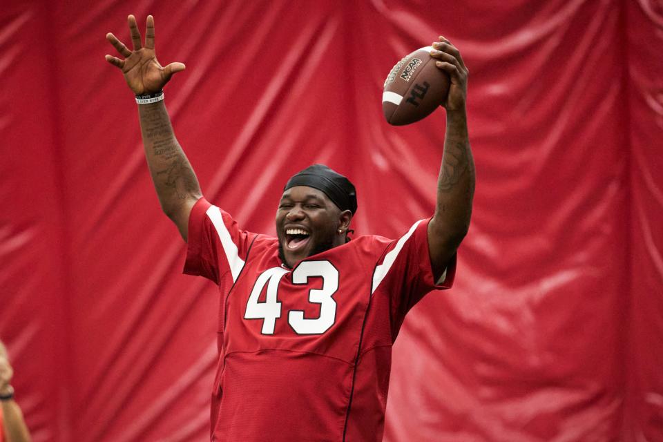 Jun 18, 2022; Tempe, Arizona, USA; Arizona Cardinals offensive linebacker Jesse Luketa (43) celebrates someone catching the ball during a youth football camp at the Cardinals' training facility.