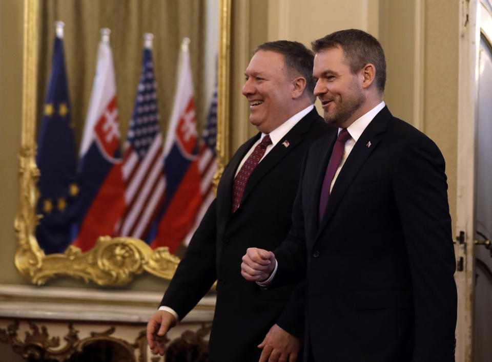 Slovakia's Prime Minister Peter Pellegrini, right, welcomes US Secretary of State Mike Pompeo, left, during his visit to Bratislava, Slovakia, Tuesday, Feb. 12, 2019. Pompeo is in Slovakia on the second leg of a five-nation European tour that began in Hungary and will take him to Poland, Belgium and Iceland. (AP Photo/Petr David Josek)