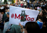 A protester raises a placard reading "#MeToo" during a rally against harassment at Shinjuku shopping and amusement district in Tokyo, Japan, April 28, 2018. REUTERS/Issei Kato