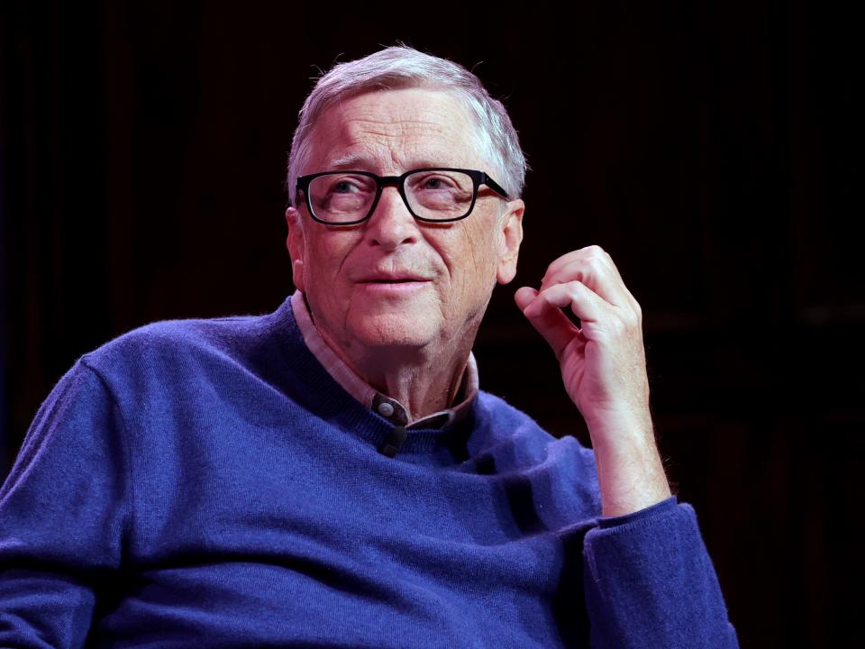 Bill Gates onstage in front of a black background.