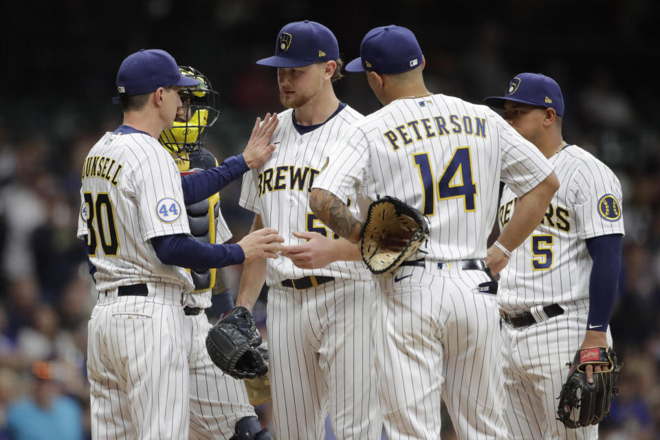 Milwaukee Brewers' Craig Counsell (30) congratulates Eric Lauer as he removes him from the game during the seventh inning of a baseball game against the New York Mets Friday, Sept. 24, 2021, in Milwaukee. (AP Photo/Aaron Gash)