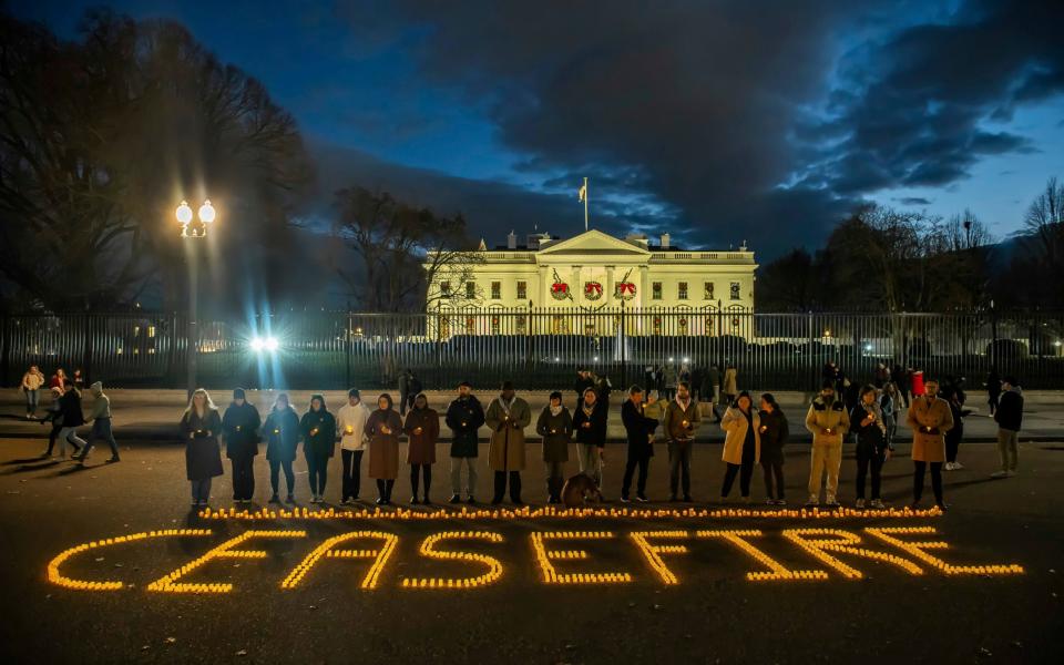 Amnesty International USA, MoveOn, Oxfam America and Win Without War place candles spelling out CEASEFIRE in front of the White House as part of a Global Day of Action for a ceasefire