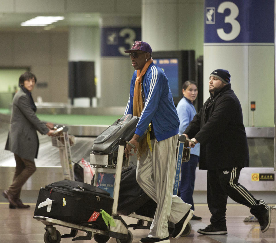 Former NBA basketball player Dennis Rodman pushes his luggage cart as he arrives at the Capital International Airport in Beijing from Pyongyang, Monday, Jan. 13, 2014. A squad of former basketball stars led by Rodman had a friendly game with North Korean basketball players in Pyongyang. (AP Photo/Alexander F. Yuan)