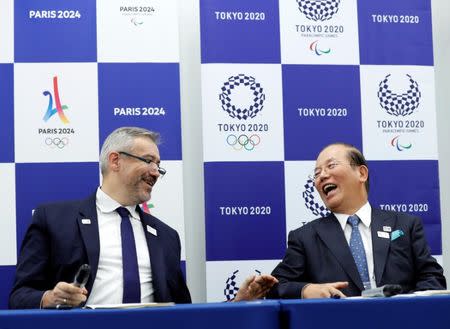 Etienne Thobois (L), Paris 2024 Director General, and Toshiro Muto, Tokyo 2020 CEO, attend a ceremony marking conclusion of MoU between Tokyo 2020 and Paris 2024 Olympic Games in Tokyo, Japan, July 11, 2018. REUTERS/Kim Kyung-Hoon