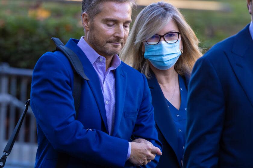 VAN NUYS, CA - JANUARY 23: Rebecca Grossman, right, tightly holding on to her husband Peter Grossman heads into Van Nuys Courthouse West on Tuesday, Jan. 23, 2024 in Van Nuys, CA. (Irfan Khan / Los Angeles Times)