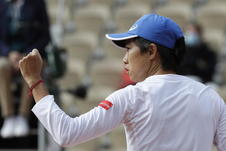 China's Zhang Shuai clenches her fist after scoring a point against France's Clara Burel in the third round match of the French Open tennis tournament at the Roland Garros stadium in Paris, France, Saturday, Oct. 3, 2020. (AP Photo/Alessandra Tarantino)