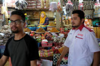 A stall keeper tends to her stall at a market in Kota Bharu, Kelantan, Malaysia April 12, 2018. Picture taken April 12, 2018. REUTERS/Stringer