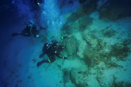 Diver and technical director Markos Garras, 50, inspects an amphora at a shipwreck site on the island of Fournoi, Greece, September 19, 2018. Picture taken September 19, 2018. Vassilis Mentogiannis/Hellenic Ephorate of Underwater Antiquities/Handout via REUTERS ATTENTION EDITORS - THIS PICTURE WAS PROVIDED BY A THIRD PARTY.