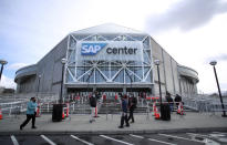 Staff arrive for COVID-19 testing before entering SAP Center for an NHL hockey game between the Vegas Golden Knights and the San Jose Sharks in San Jose, Calif., Saturday, Feb. 13, 2021. (AP Photo/Josie Lepe)