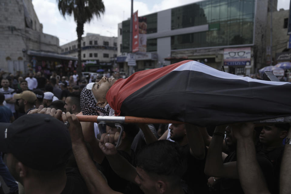 Palestinian mourners carry the body of Khalil Yahya Anis during his funeral in the West Bank city of Nablus, Thursday, June 15, 2023. The Palestinian Health Ministry said the 20-year-old man was shot in the head by Israeli forces. The Israeli military said troops operating in the city came under fire and fired back.(AP Photo/Nasser Nasser)