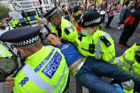 Police officers remove an Extinction Rebellion protester from Parliament Square, Westminster, London. (Photo by Dominic Lipinski/PA Images via Getty Images)