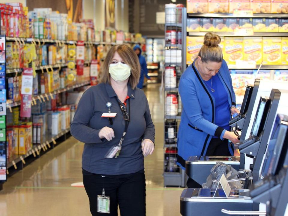  Employees working at Metro’s self-checkout area at the Devonshore Mall store.