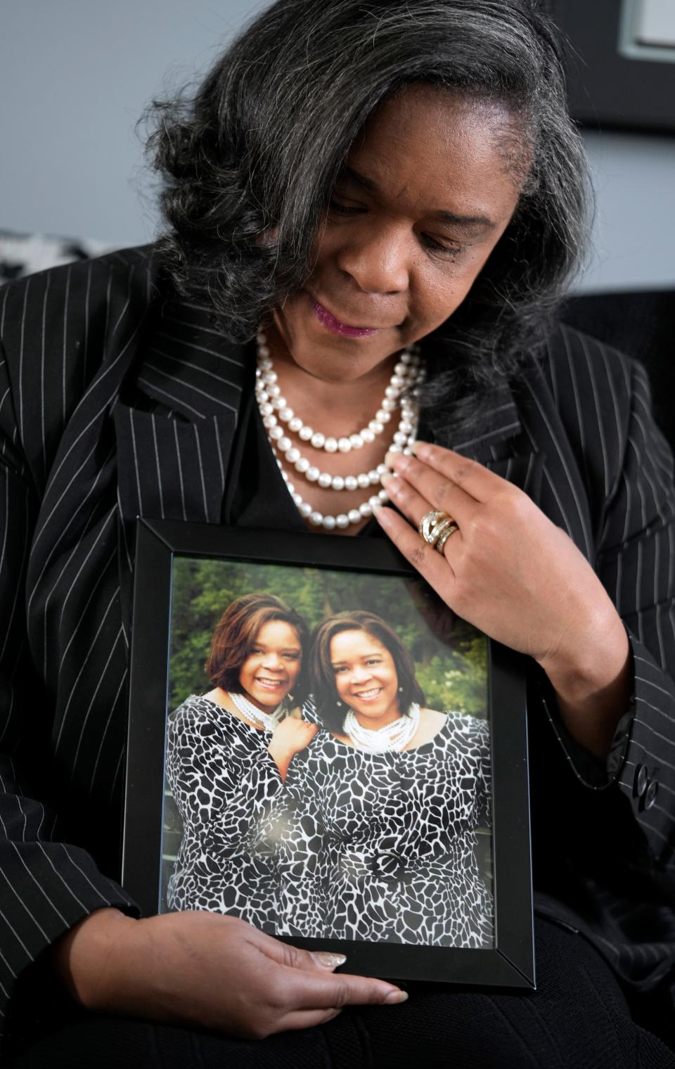 Carolyn Williams Francis holds a photo of her and her sister Carla Bailey who passed away last year from breast cancer. and also suffered from heart issues. Williams Francis has had two heart stents inserted to prevent having a heart attack herself. She believes the stress of being a Black woman business owner has had an impact on her health.