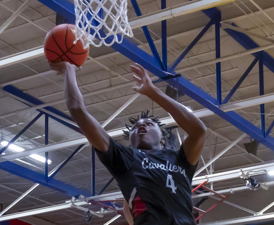 Lake Travis Cavaliers forward Jayden Thomas goes for the layup against the Westlake Chaparrals during a District 26-6A basketball game on Tuesday at Westlake High School.