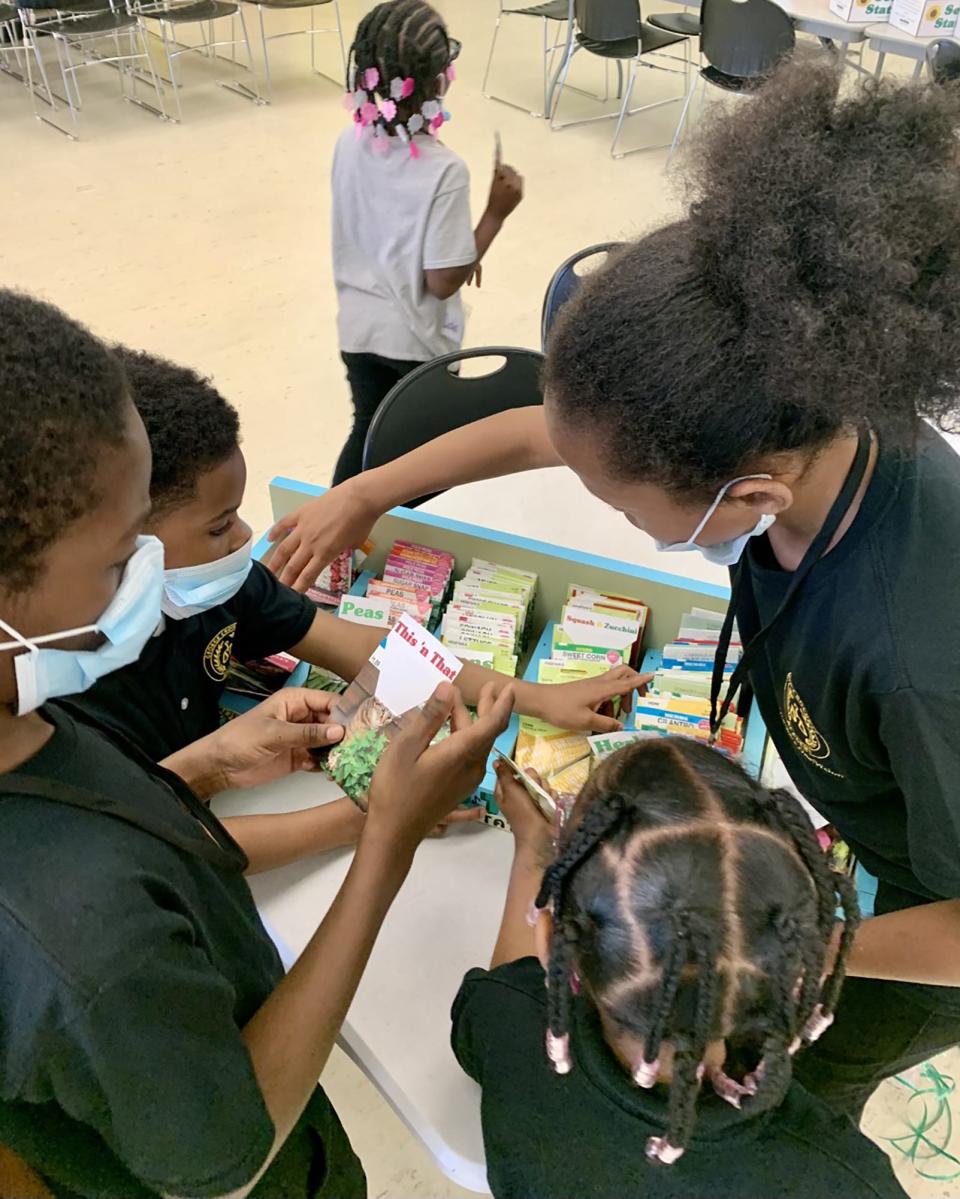 Eager gardeners choosing seeds from a Gro-Town Seed Station in the children’s library at the main branch of the Detroit Public Library on Woodward Avenue in Detroit on Thursday, April 13, 2023.