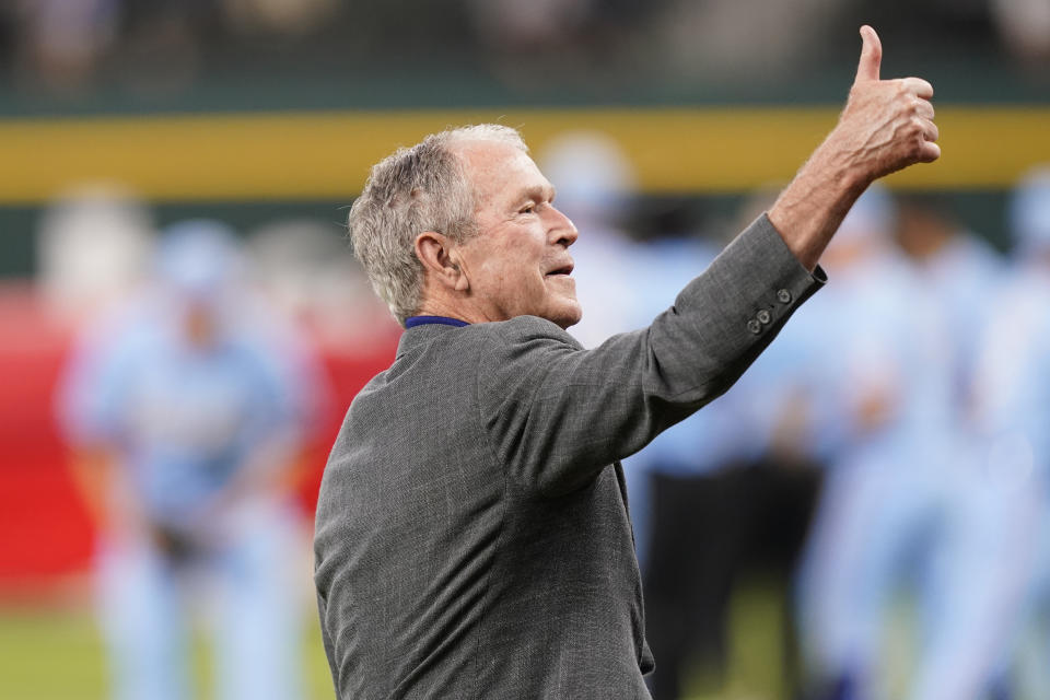 Former President George W. Bush gives a thumbs-up after the first pitch to recognize the 21st anniversary of Patriot Day before a baseball game between the Toronto Blue Jays and the Texas Rangers in Arlington, Texas, Sunday, Sept. 11, 2022. (AP Photo/LM Otero)