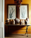 <p> If you have a collection of favorite pieces, gathering them together can make for an impactful home decor ideas. You only have to look at Gwyneth Paltrow's china display to see how effective it can be.  </p> <p> Key to creating a display is finding the right backdrop, and the more dramatic the color, the more successful the effect. We love the use of the bold yellow above. </p> <p> 'Sometimes you need a deeper golden color with more clout as some yellows can be too grey, too flat or just too primary,' says Edward Bulmer, interior designer and founder, Edward Bulmer Natural Paint. 'Earthy tobacco shades will work in any room you want to feel warm and intriguing; it is a serious color, elegant and sophisticated, which creates a fabulous backdrop to artwork and antiques, and works in a variety of spaces.' </p>