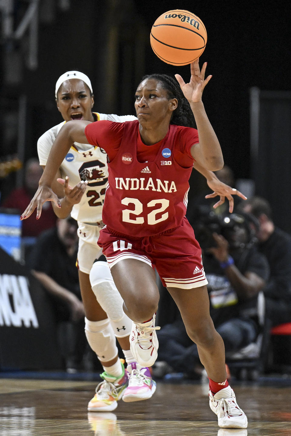 Indiana guard Chloe Moore-McNeil (22) pushes the ball down court on a fast break against South Carolina guard Bree Hall (23) during the first quarter of a Sweet Sixteen round college basketball game during the NCAA Tournament, Friday, March 29, 2024, in Albany, N.Y. (AP Photo/Hans Pennink)