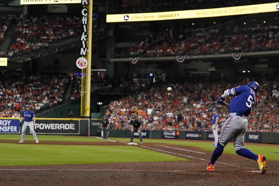 Texas Rangers' Adolis Garcia hits a grand slam during the ninth inning of Game 6 of the baseball AL Championship Series against the Houston Astros Sunday, Oct. 22, 2023, in Houston. (AP Photo/Godofredo A. Vásquez)