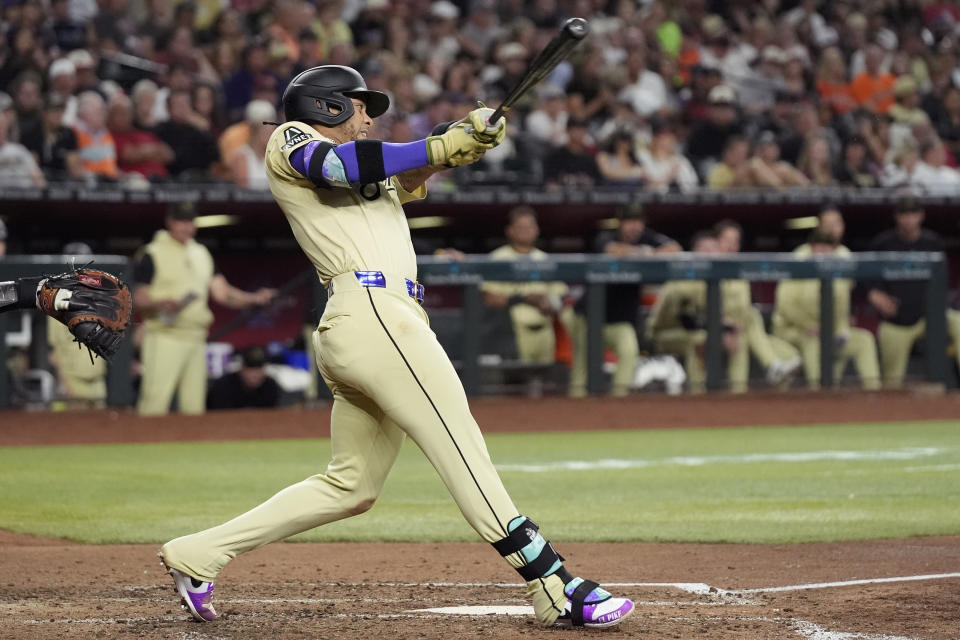 Arizona Diamondbacks' Ketel Marte connects for a run-scoring triple against the Detroit Tigers during the sixth inning of a baseball game Saturday, May 18, 2024, in Phoenix. (AP Photo/Ross D. Franklin)