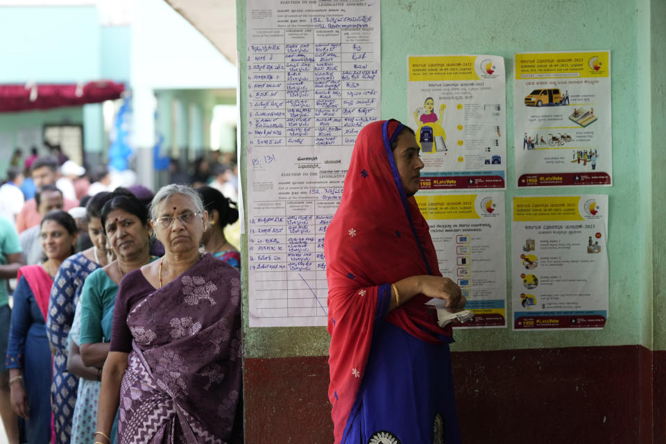 Women wait in a queue to caste their votes at a polling station in Bengaluru, India, Wednesday, May 10, 2023. Thousands of people began voting Wednesday in a key southern Indian state where pre-poll projections have put the opposition Congress ahead of Prime Minister Narendra Modi's governing Hindu nationalist party. (AP Photo/Aijaz Rahi)