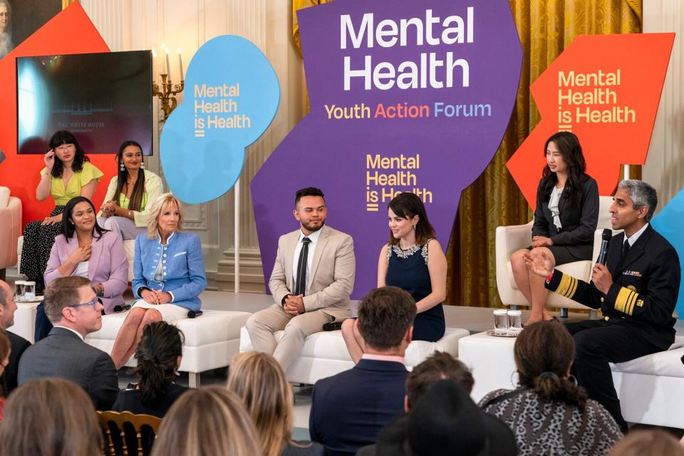 Front row from left, youth mental health leader Ayanna Kelly, first lady Jill Biden, youth mental health leader Juan Acosta, actress and mental health advocate Selena Gomez, listen as Surgeon General Dr. Vivek Murthy, speaks during the White House Conversation on Youth Mental Health, Wednesday, May 18, 2022, at the White House in Washington.