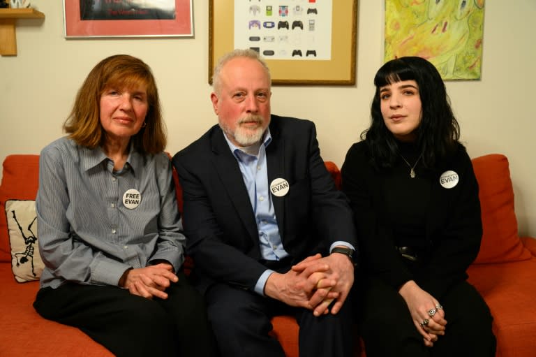 Ella Milman, Danielle and Mikhail Gershkovich, mother, sister and father to detained journalist, Evan Gershkovich, sit for a portrait in Danielle's apartment in Philadelphia, Pennsylvania in February 2024 (Kriston Jae Bethel)