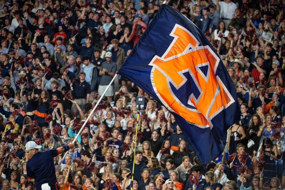 AUBURN, ALABAMA - SEPTEMBER 14: A cheerleader with the Auburn Tigers waves their flag during their game against the New Mexico Lobos at Jordan-Hare Stadium on September 14, 2024 in Auburn, Alabama.  (Photo by Michael Chang/Getty Images) *** Local Caption ***