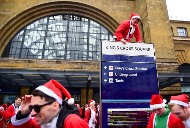 Man in Santa costume climbs sign