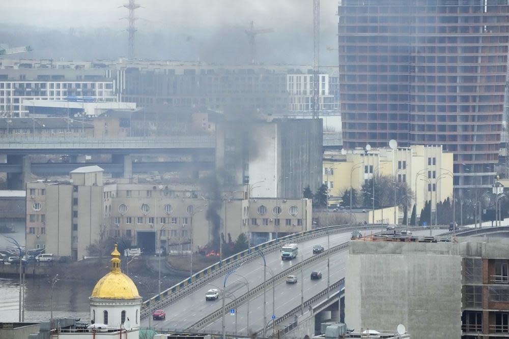 Smoke and flame rise near a military building after an apparent Russian strike in Kyiv, Ukraine, Thursday, Feb. 24, 2022. Russian troops have launched their anticipated attack on Ukraine. Big explosions were heard before dawn in Kyiv, Kharkiv and Odesa as world leaders decried the start of a Russian invasion that could cause massive casualties and topple Ukraine's democratically elected government.