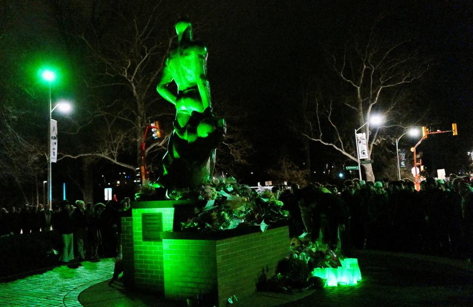 Sparty is lit up green at the vigil held on the Michigan State campus Tuesday, Feb. 13, 2024, marking the one year anniversary of the mass shooting that killed three students.