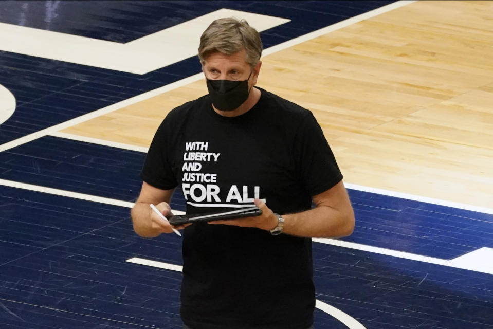 Minnesota Timberwolves head coach Chris Finch returns to his seat after a timeout in the first half of an NBA basketball game against the Milwaukee Bucks, Wednesday, April 14, 2021, in Minneapolis. (AP Photo/Jim Mone)