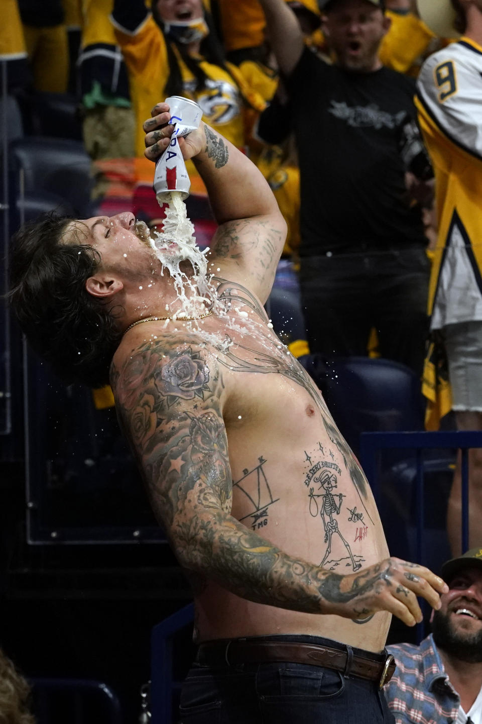 Tennessee Titans NFL football offensive lineman Taylor Lewan celebrates after a goal by the Nashville Predators during the second period in Game 4 of an NHL hockey Stanley Cup first-round playoff series between the Predators and the Carolina Hurricanes Sunday, May 23, 2021, in Nashville, Tenn. (AP Photo/Mark Humphrey)